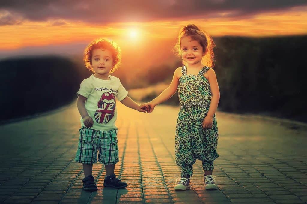 Image of happy children smiling in the sunset, because of their NJ child support